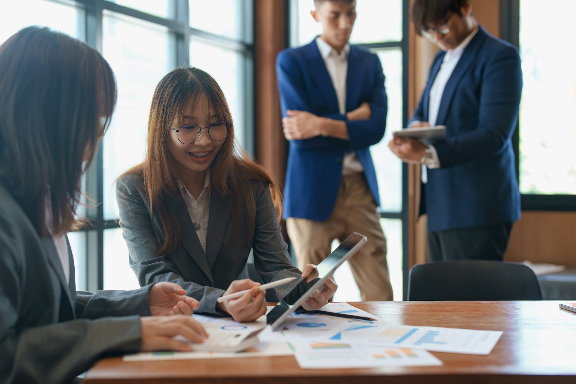 Group of coworkers young asian working together on business project in office